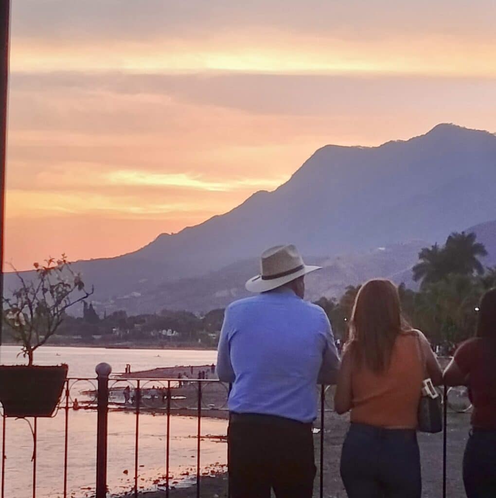 Couple watching the sunset in Ajijic, Mexico. 